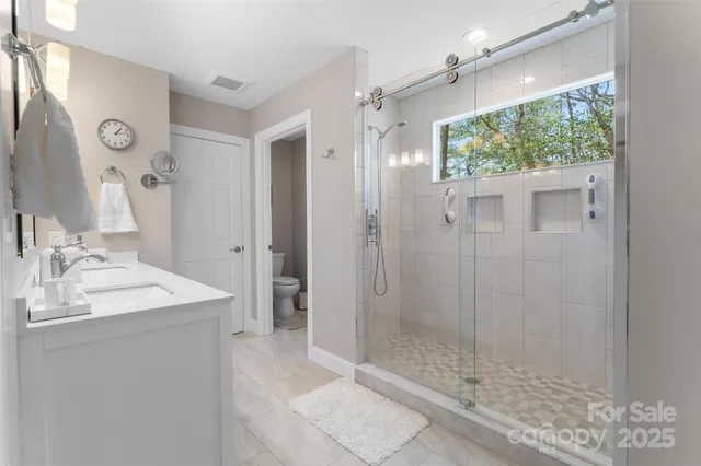 a bathroom with a shower sink and mirror