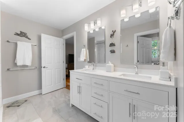 a bathroom with a double vanity sink and a mirror