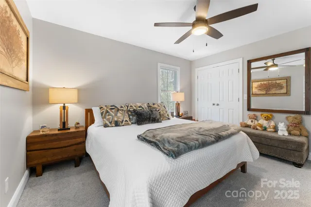a spacious bedroom with a bed and a chandelier