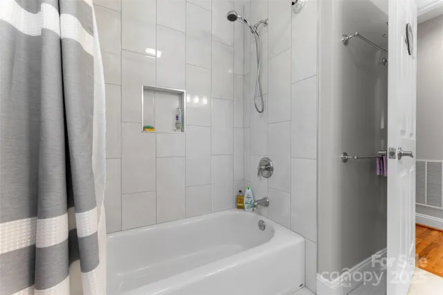 a bathroom with a bathtub and a shower