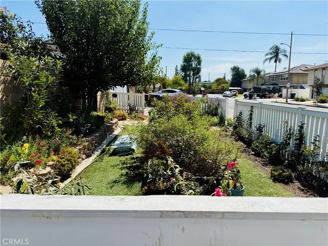 a view of a house with a small yard and a garage