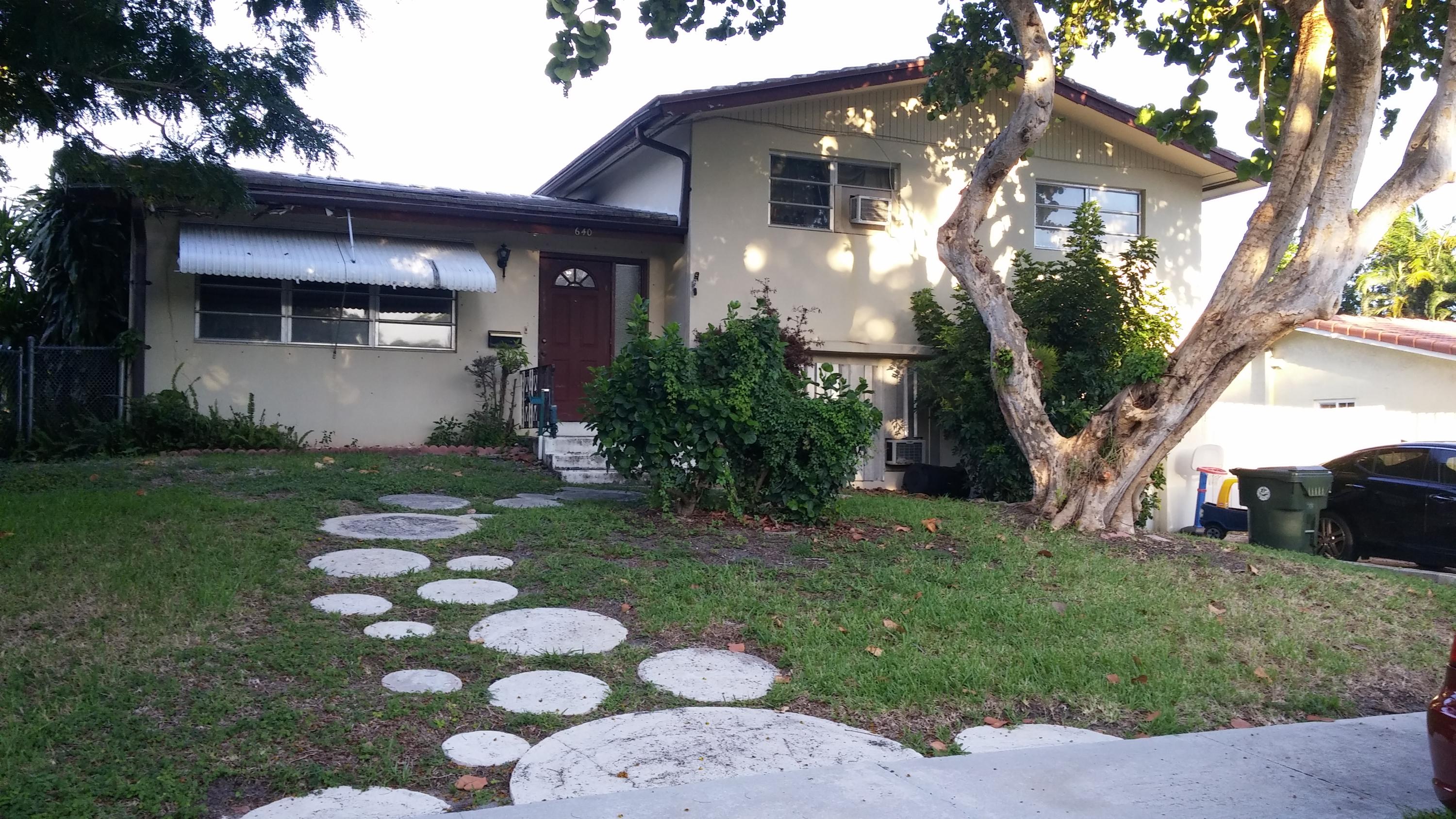 640 Northwest 16th Avenue Boca Raton, FL 33486 - Photo 1 of 5 a front view of a house with garden