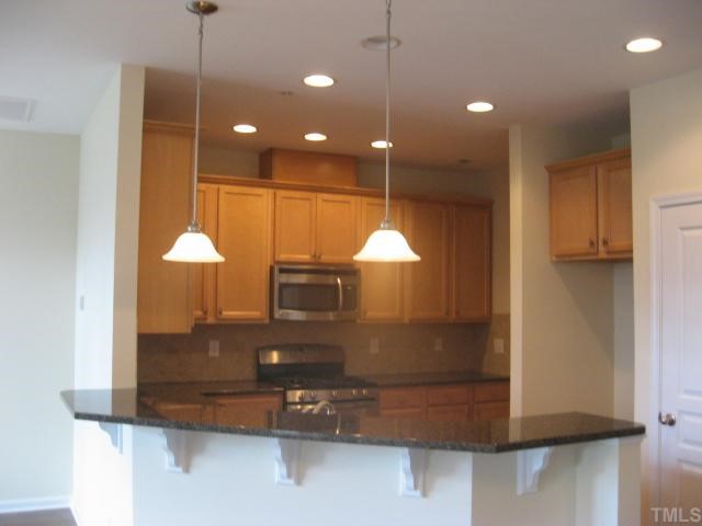9133 Wooden Road, Unit 242 Raleigh, NC 27617 - Photo 2 of 9 Open Kitchen with Granite Countertops and Stainless Steel Appliances!