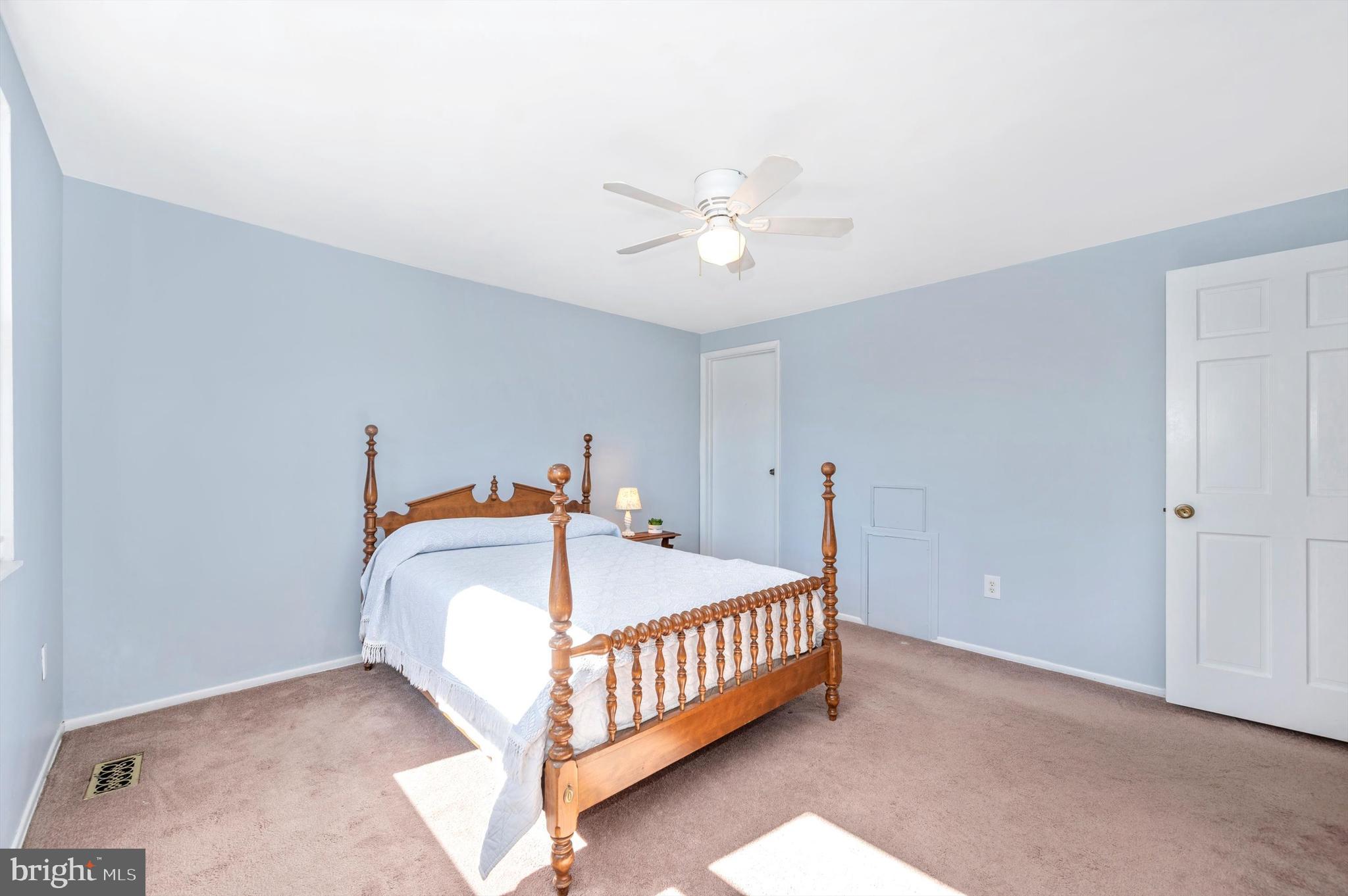 17526 Kohlhoss Road Poolesville, MD 20837 - Photo 22 of 42 a bedroom with a bed and a chandelier