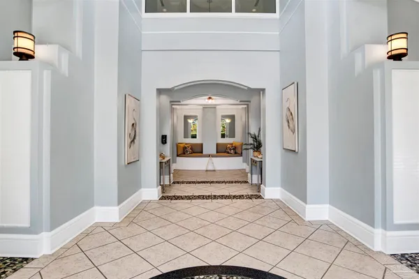 a view of a hallway with windows and livingroom