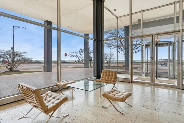 a living room with furniture and floor to ceiling windows