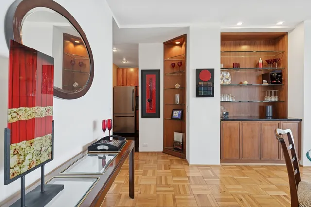 a hallway with a dining table and a stove top oven with wooden floor