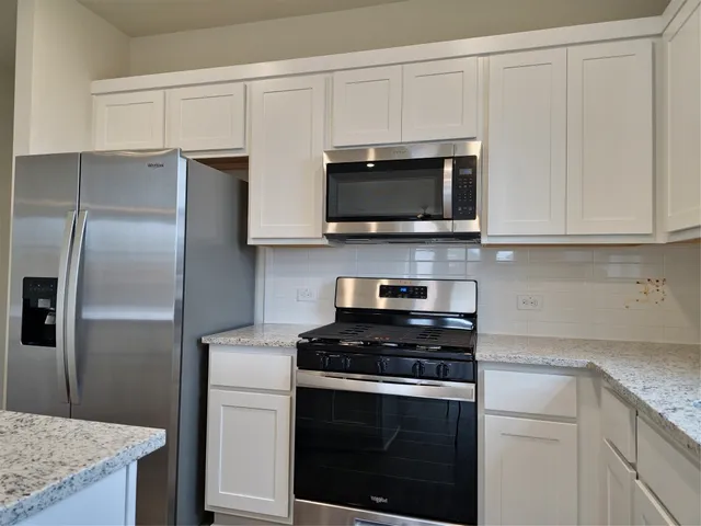 a kitchen with cabinets stainless steel appliances and a sink