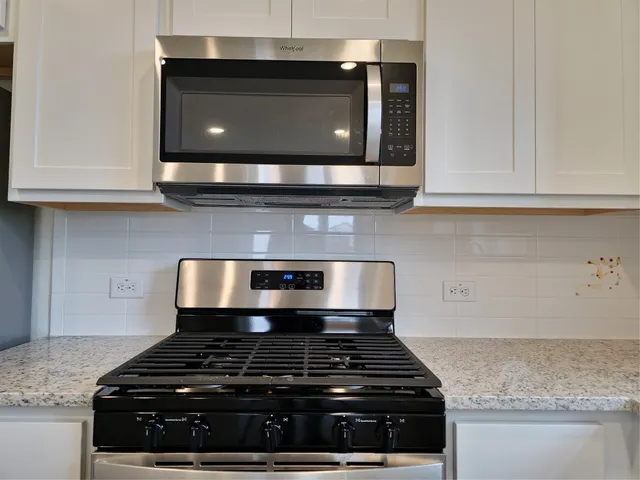 a stove top oven sitting inside of a kitchen