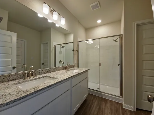 a bathroom with a granite countertop sink mirror and double