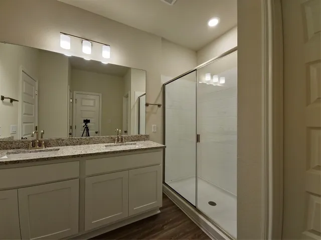 a bathroom with a double vanity sink mirror and double