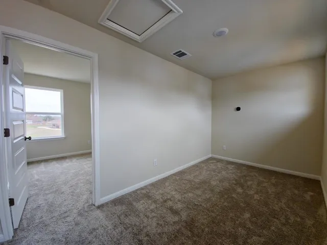 an empty room with a empty space and windows