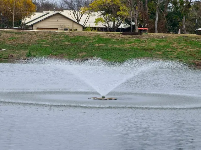 a view of a house with a yard and a parking space
