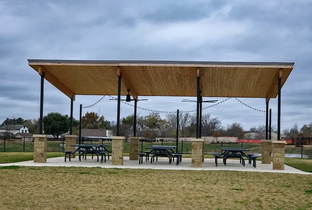a view of a swimming pool with lawn chairs under an umbrella