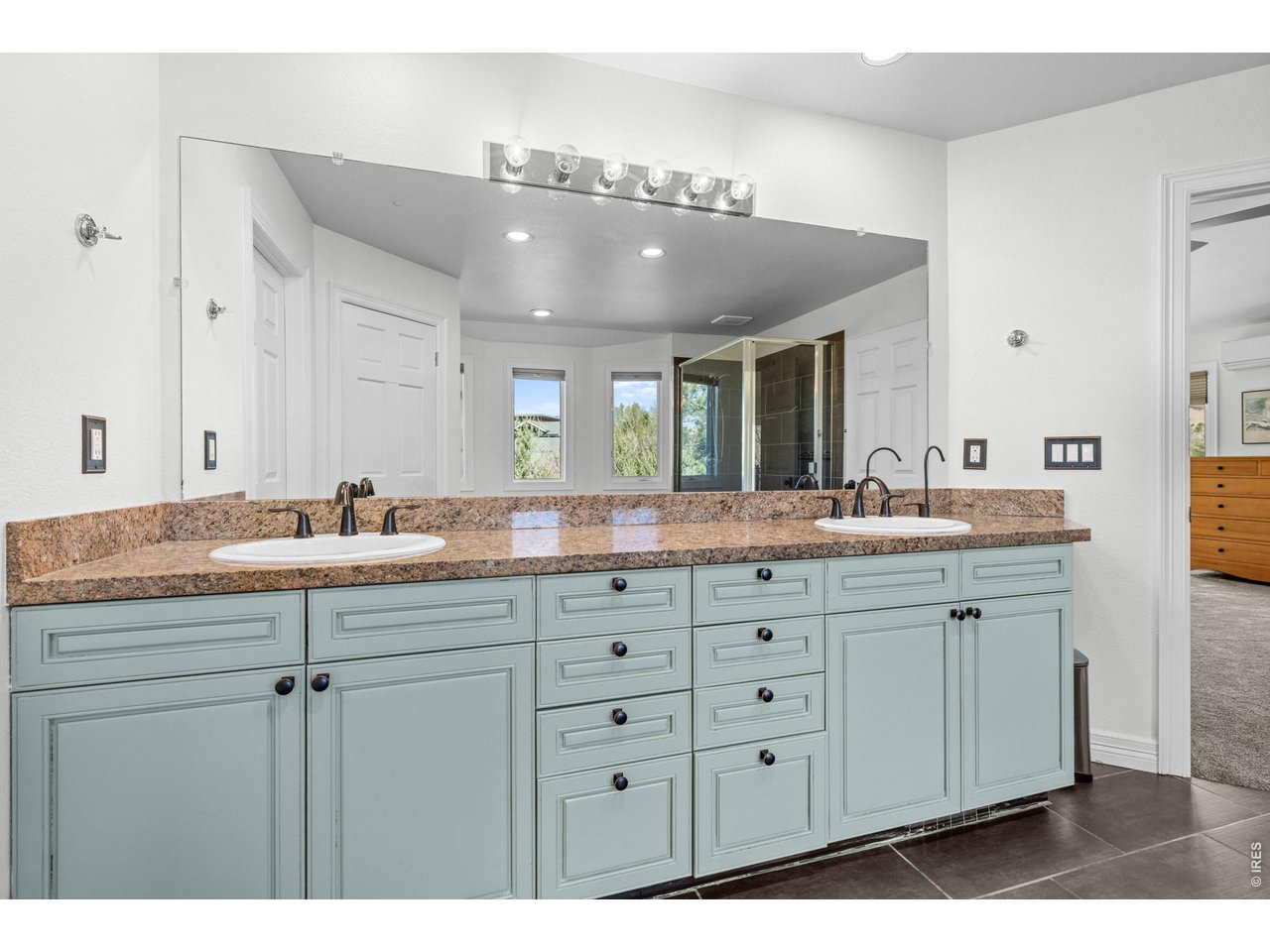 4825 6th Street Boulder, CO 80304 - Photo 21 of 50 a bathroom with a granite countertop sink a large mirror and a