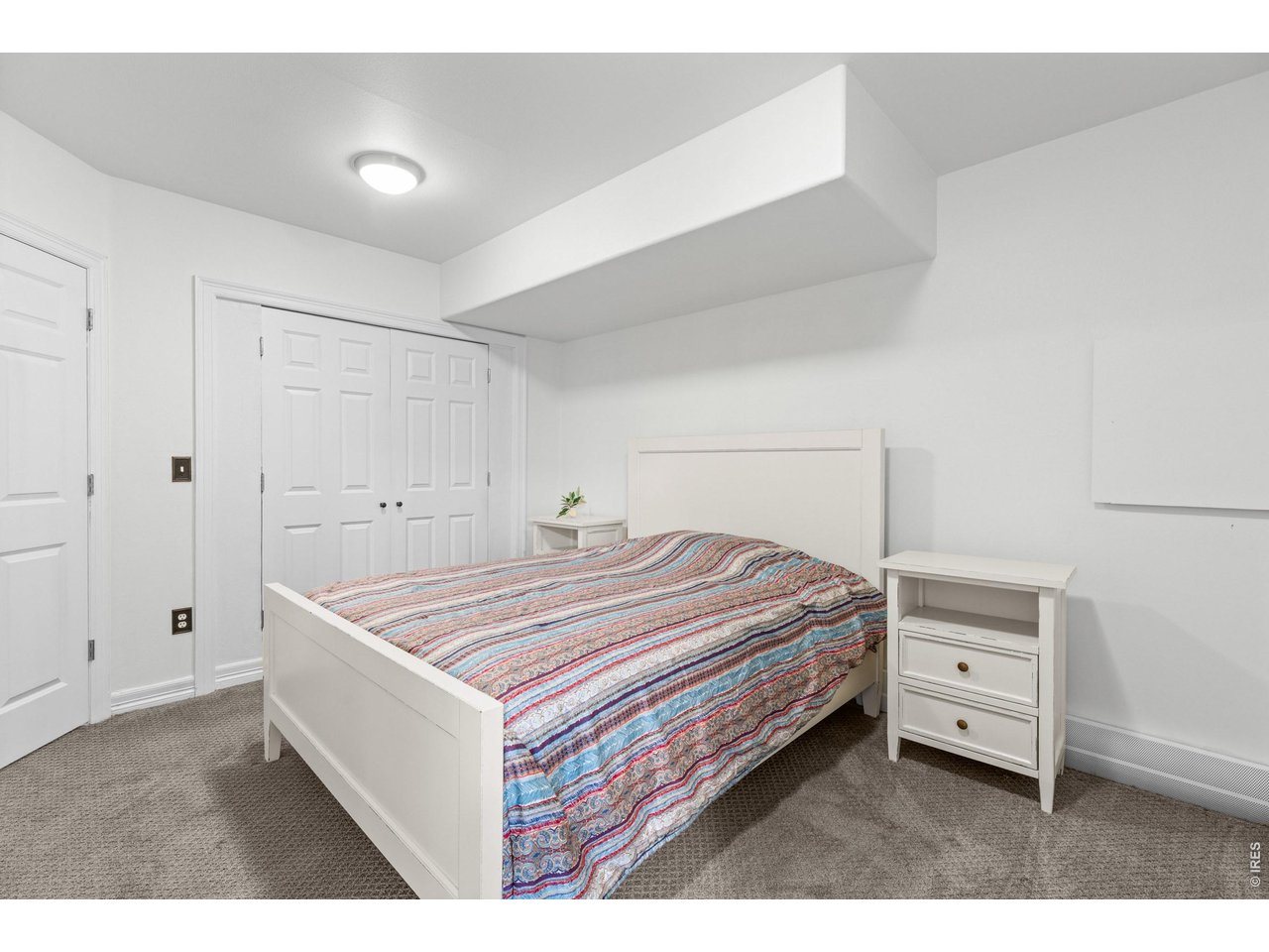 4825 6th Street Boulder, CO 80304 - Photo 27 of 50 a bedroom with a bed and a cabinets