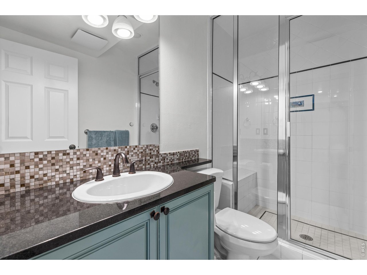 4825 6th Street Boulder, CO 80304 - Photo 29 of 50 a bathroom with a sink toilet a mirror and shower