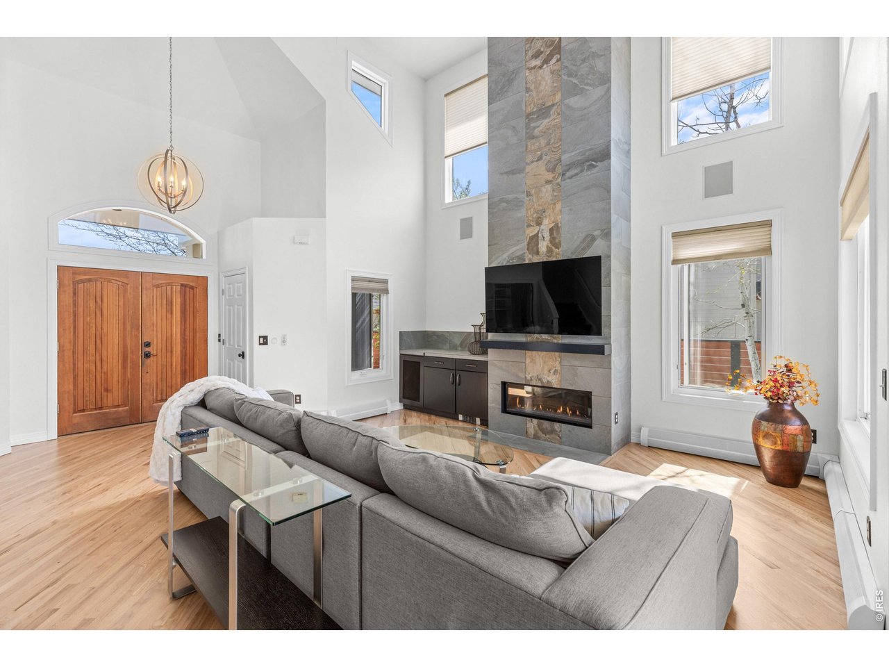 4825 6th Street Boulder, CO 80304 - Photo 5 of 50 a living room with furniture a flat screen tv and kitchen view