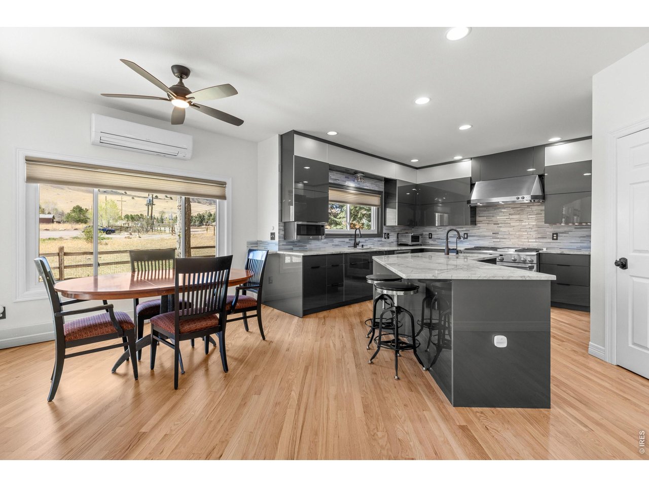 4825 6th Street Boulder, CO 80304 - Photo 6 of 50 a dining room with kitchen island stainless steel appliances wooden floor dining table and chairs