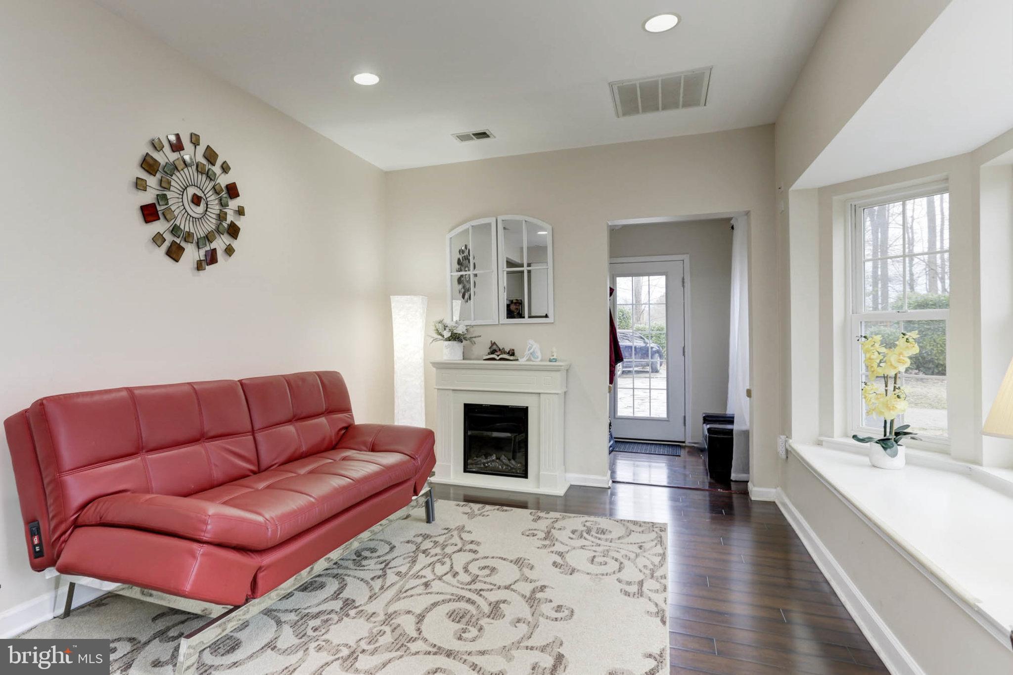 7465 Browns Bridge Road Highland, MD 20777 - Photo 29 of 37 a living room with furniture or couch and a fireplace