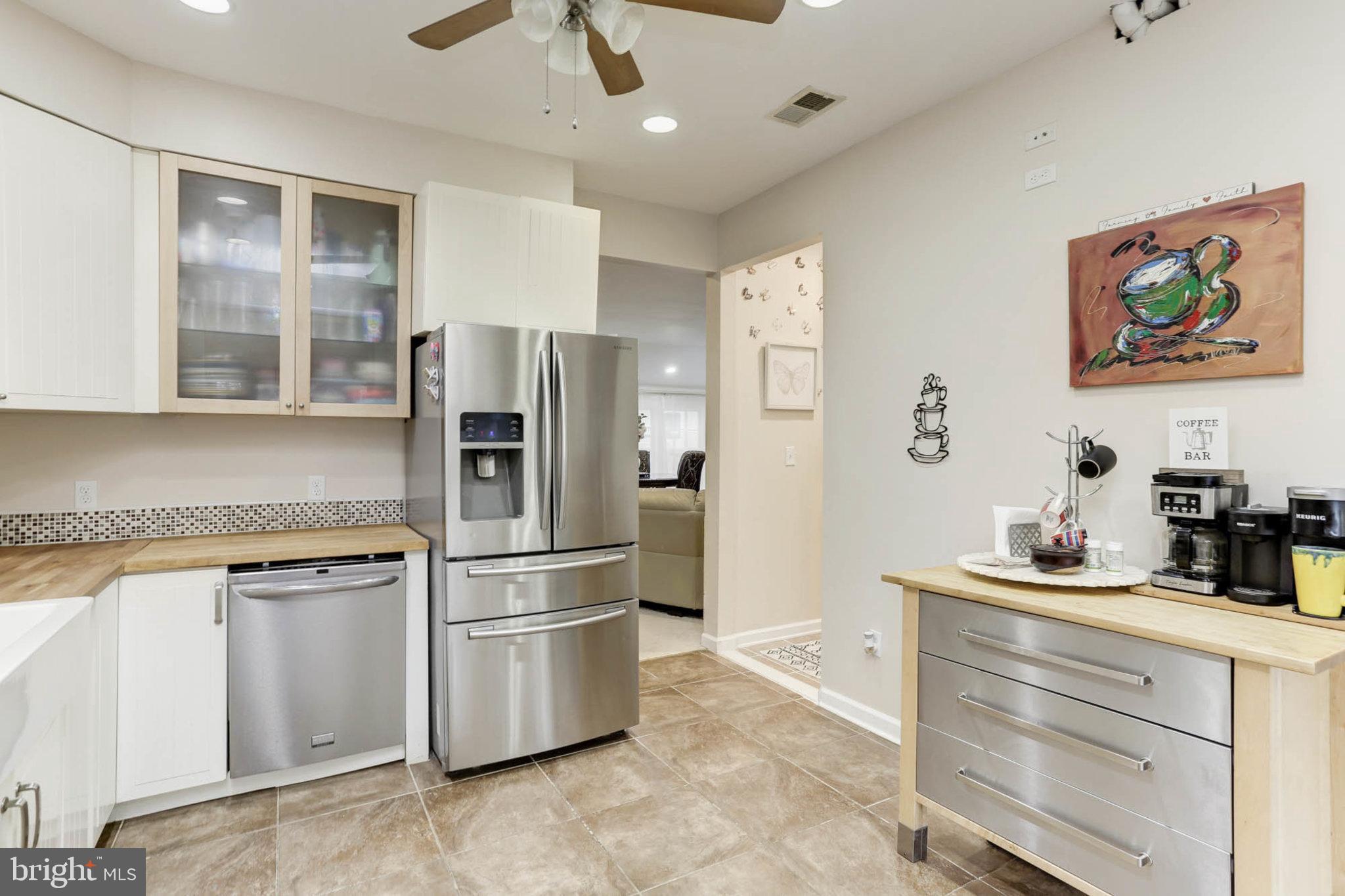 7465 Browns Bridge Road Highland, MD 20777 - Photo 8 of 37 a kitchen with stainless steel appliances granite countertop a refrigerator and a stove top oven