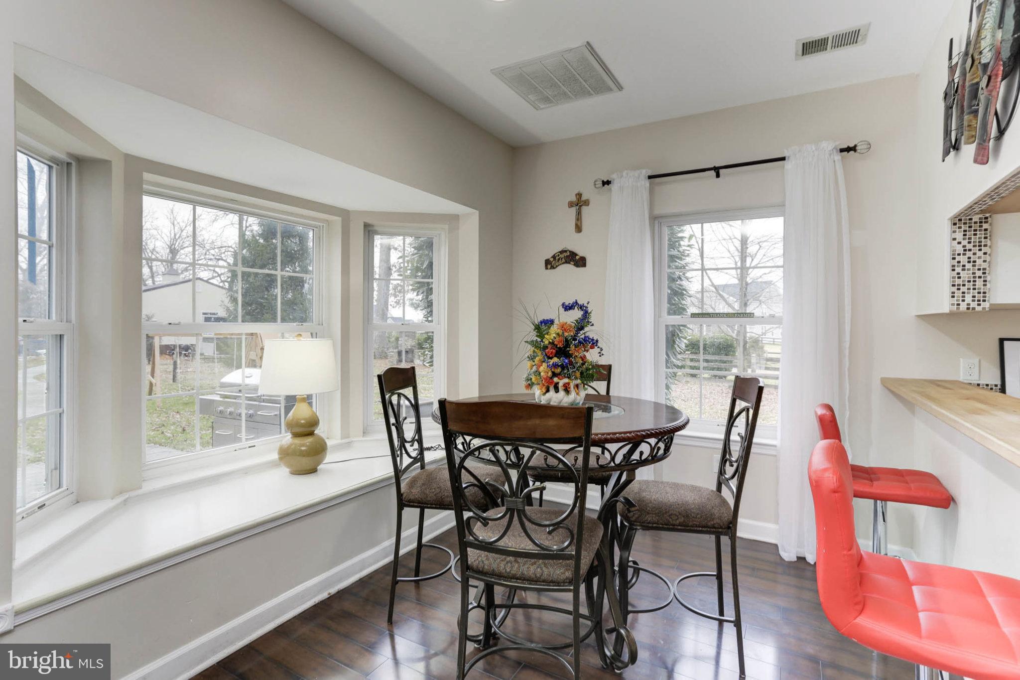 7465 Browns Bridge Road Highland, MD 20777 - Photo 10 of 37 a view of a dining room with furniture and wooden floor