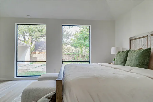 a bedroom with a bed and windows