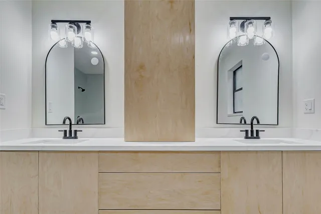 a bathroom with a double vanity sink and a mirror