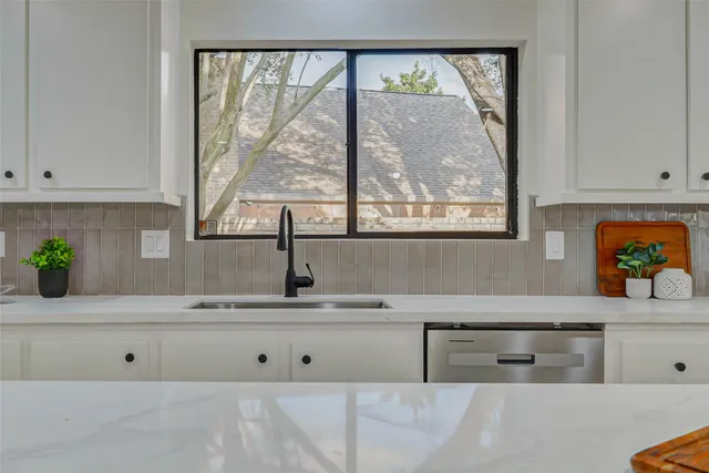 a kitchen with a window a sink and a window