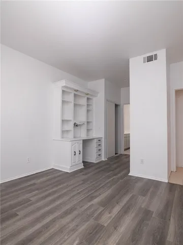 a view of a kitchen with wooden floor and a sink