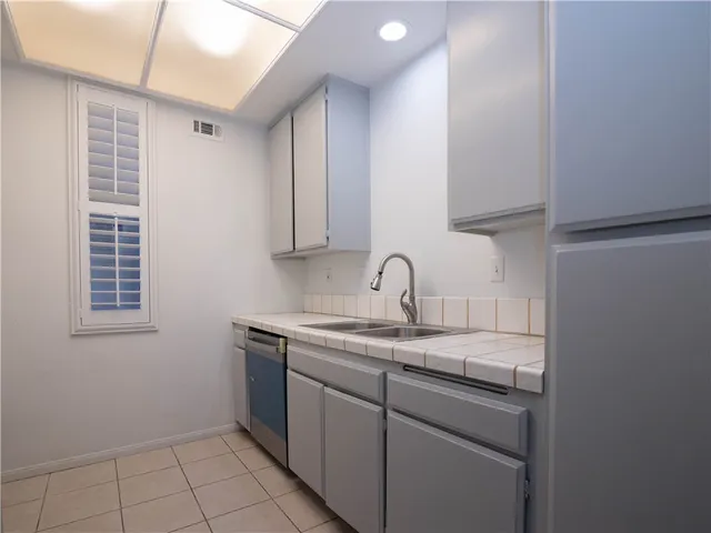 a kitchen with a sink cabinets and window