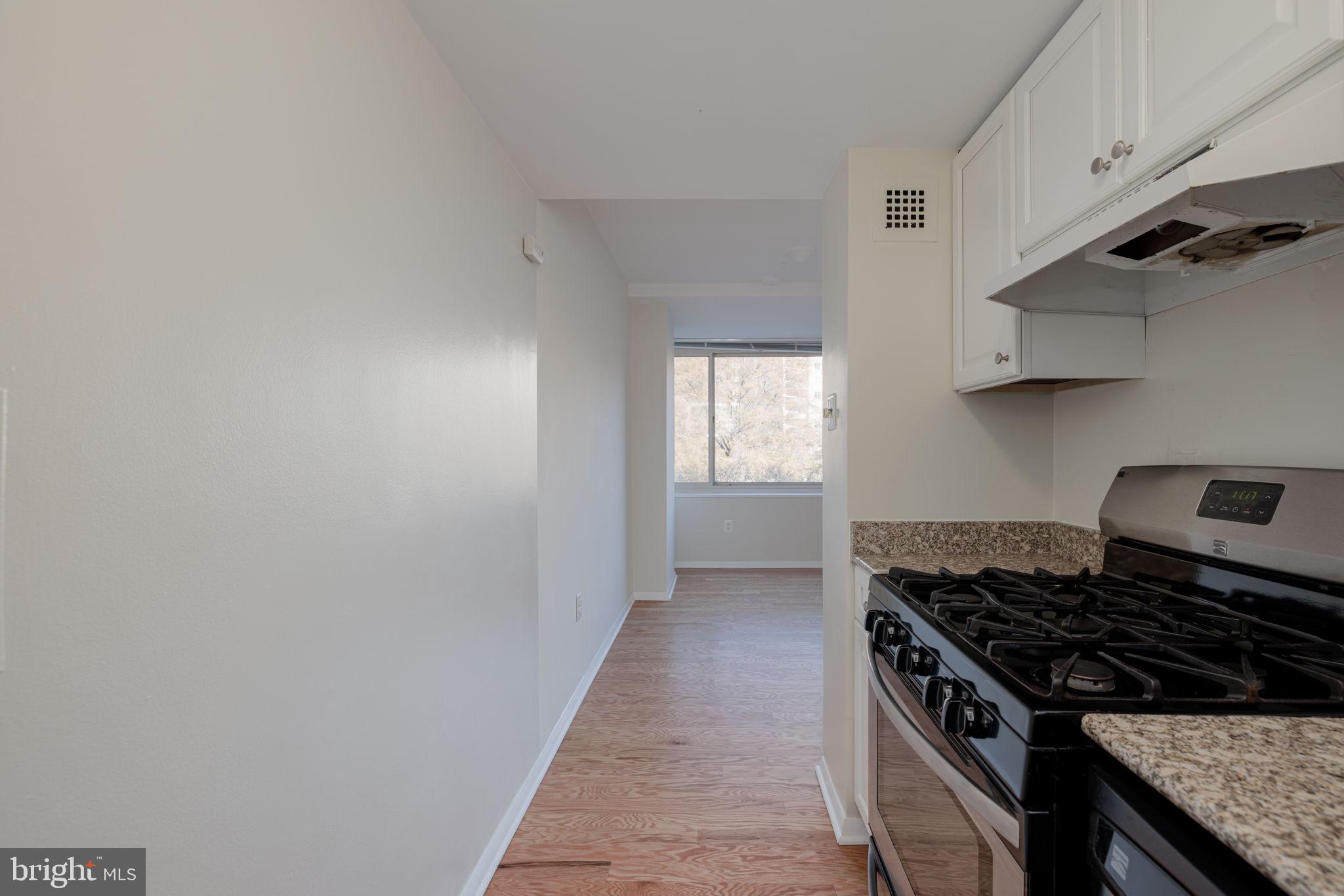 4000 Tunlaw Road Northwest, Unit 600 Washington, DC 20007 - Photo 12 of 27 a kitchen with granite countertop a stove and a sink