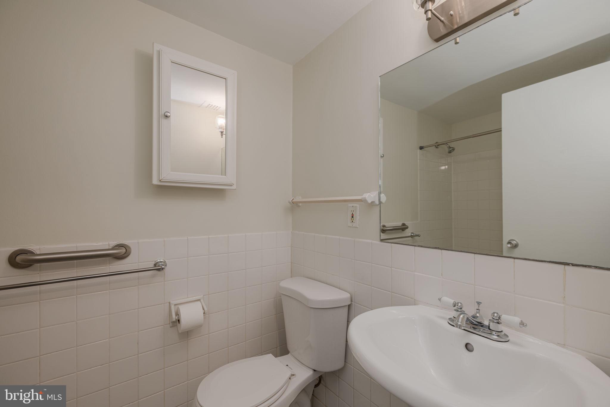 4000 Tunlaw Road Northwest, Unit 600 Washington, DC 20007 - Photo 14 of 27 a bathroom with a toilet sink and mirror
