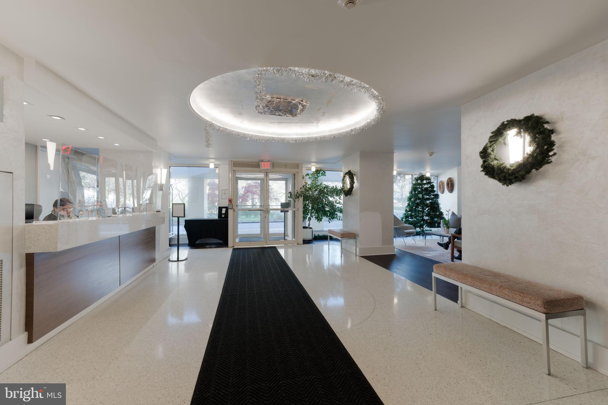 4000 Tunlaw Road Northwest, Unit 600 Washington, DC 20007 - Photo 4 of 27 a lobby with furniture and a potted plant