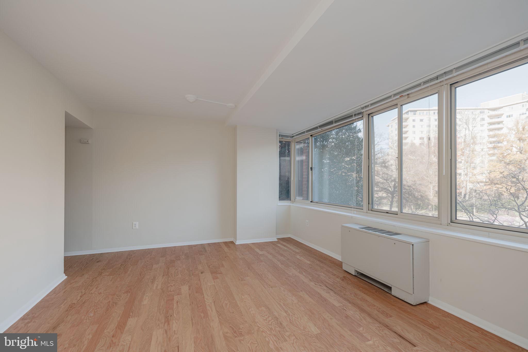 4000 Tunlaw Road Northwest, Unit 600 Washington, DC 20007 - Photo 7 of 27 a view of an empty room with wooden floor and a window