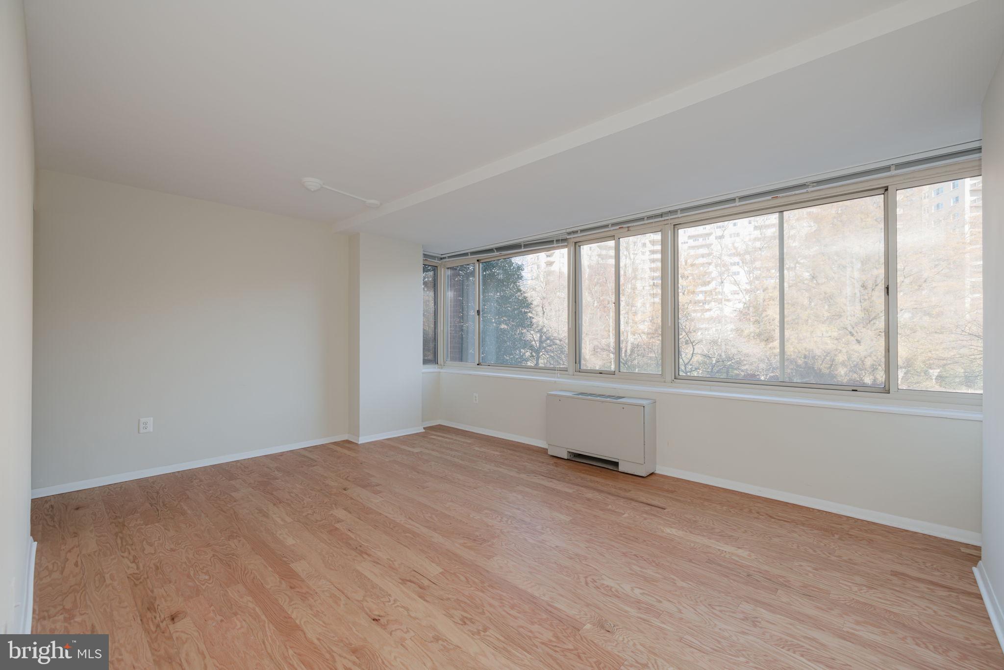 4000 Tunlaw Road Northwest, Unit 600 Washington, DC 20007 - Photo 8 of 27 wooden floor in an empty room with a window