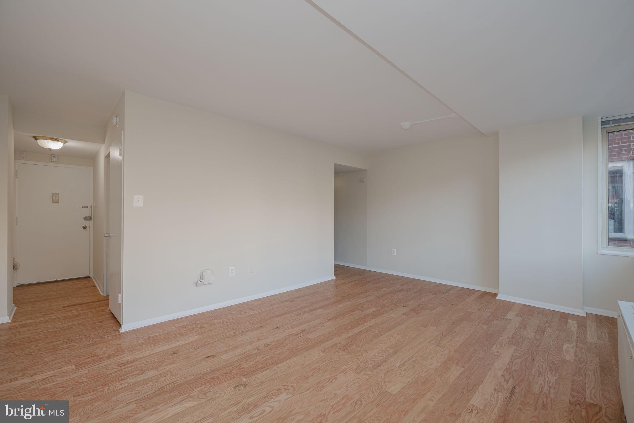 4000 Tunlaw Road Northwest, Unit 600 Washington, DC 20007 - Photo 9 of 27 a view of an empty room with wooden floor