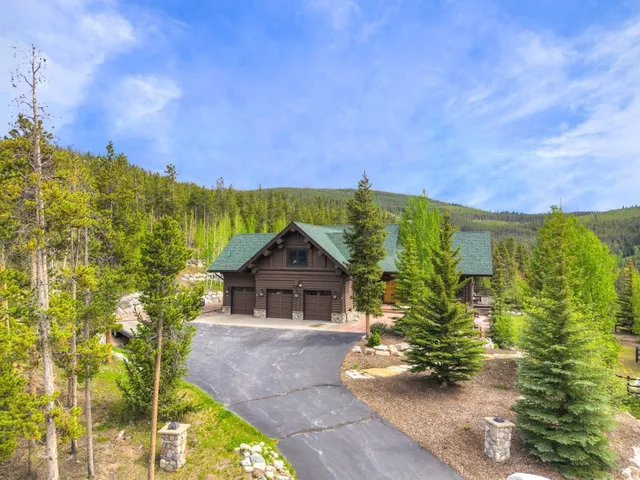 a view of a patio with a dining table and chairs with a barbeque grill and a fireplace