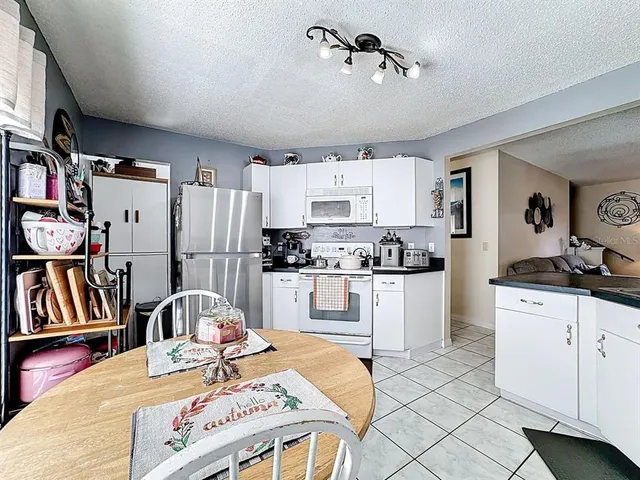 a kitchen with kitchen island a stove a sink and a refrigerator