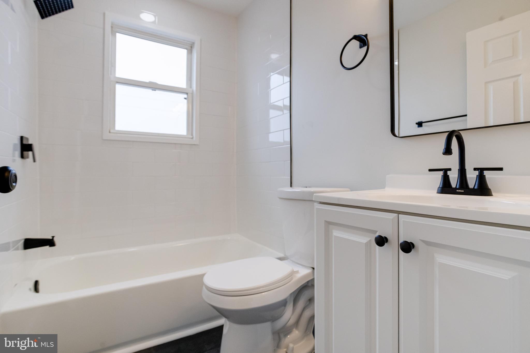 3916 2nd Street Baltimore, MD 21225 - Photo 11 of 20 a bathroom with a sink a toilet and shower