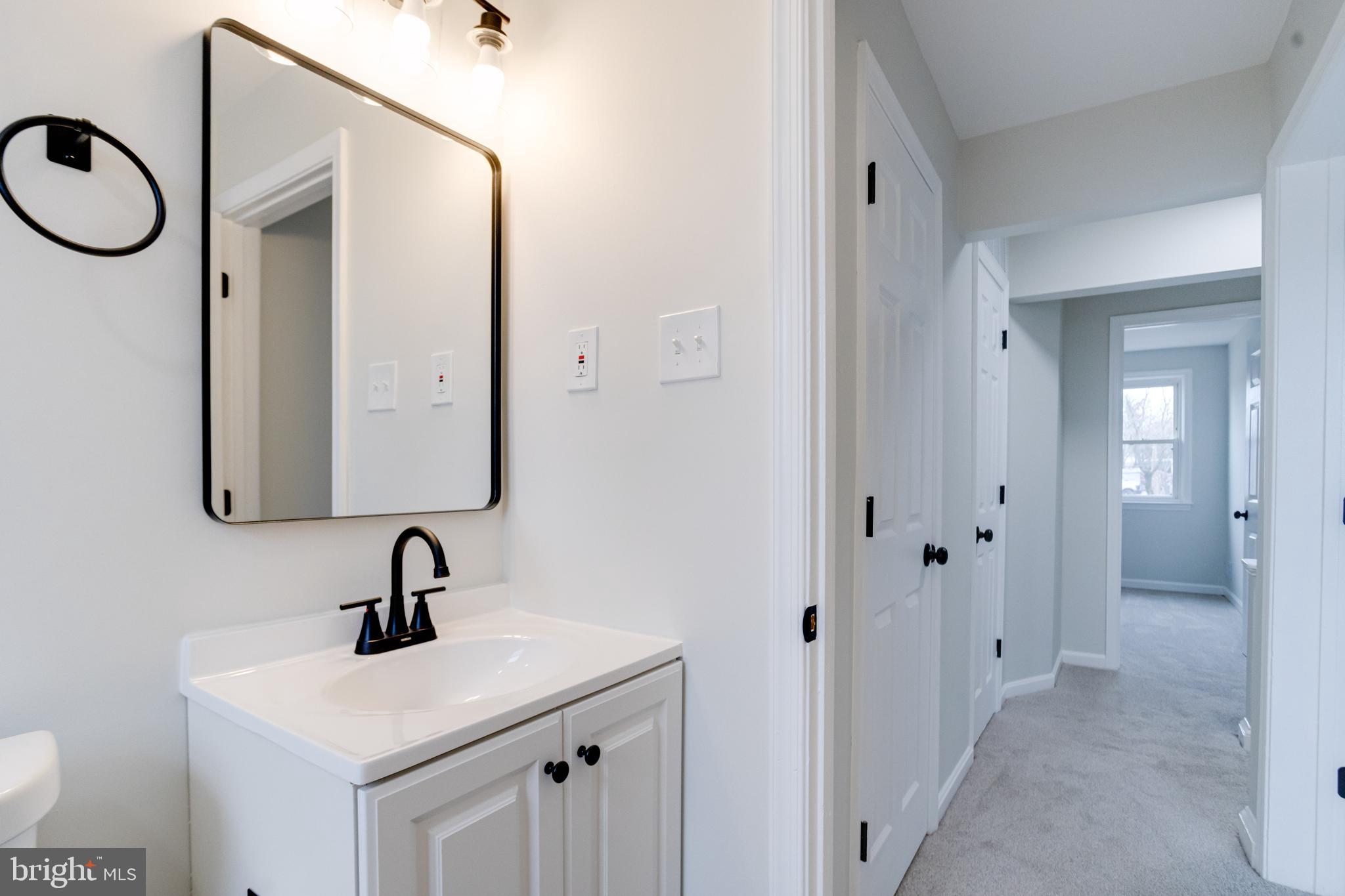 3916 2nd Street Baltimore, MD 21225 - Photo 12 of 20 a bathroom with a sink and a mirror