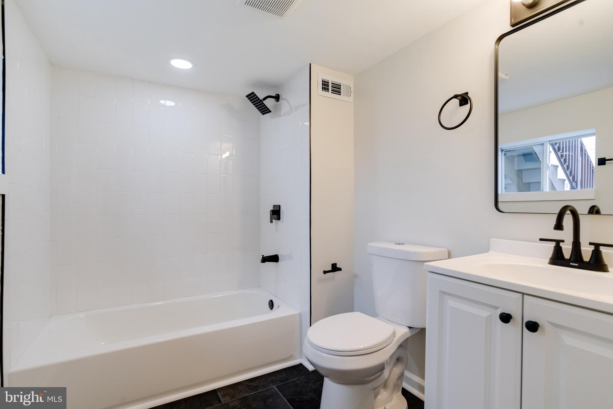 3916 2nd Street Baltimore, MD 21225 - Photo 18 of 20 a bathroom with a sink toilet and shower