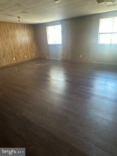 21628 Great Mills Road, Unit A2 Lexington Park, MD 20653 - Photo 8 of 11 an empty room with wooden floor and windows