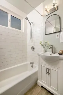 a bathroom with a sink a toilet and mirror