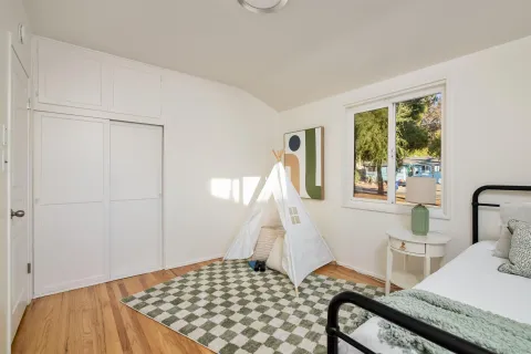 a living room with furniture potted plant and a mirror