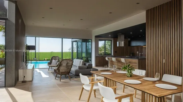 a living room with furniture and large windows