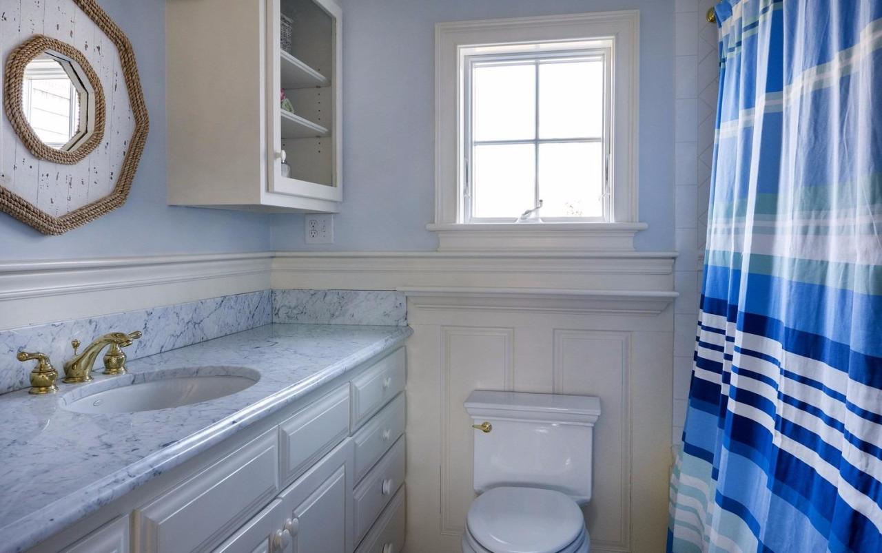 223 Stage Harbor Road Chatham, MA 02633 - Photo 25 of 35 a bathroom with a toilet a sink and a mirror