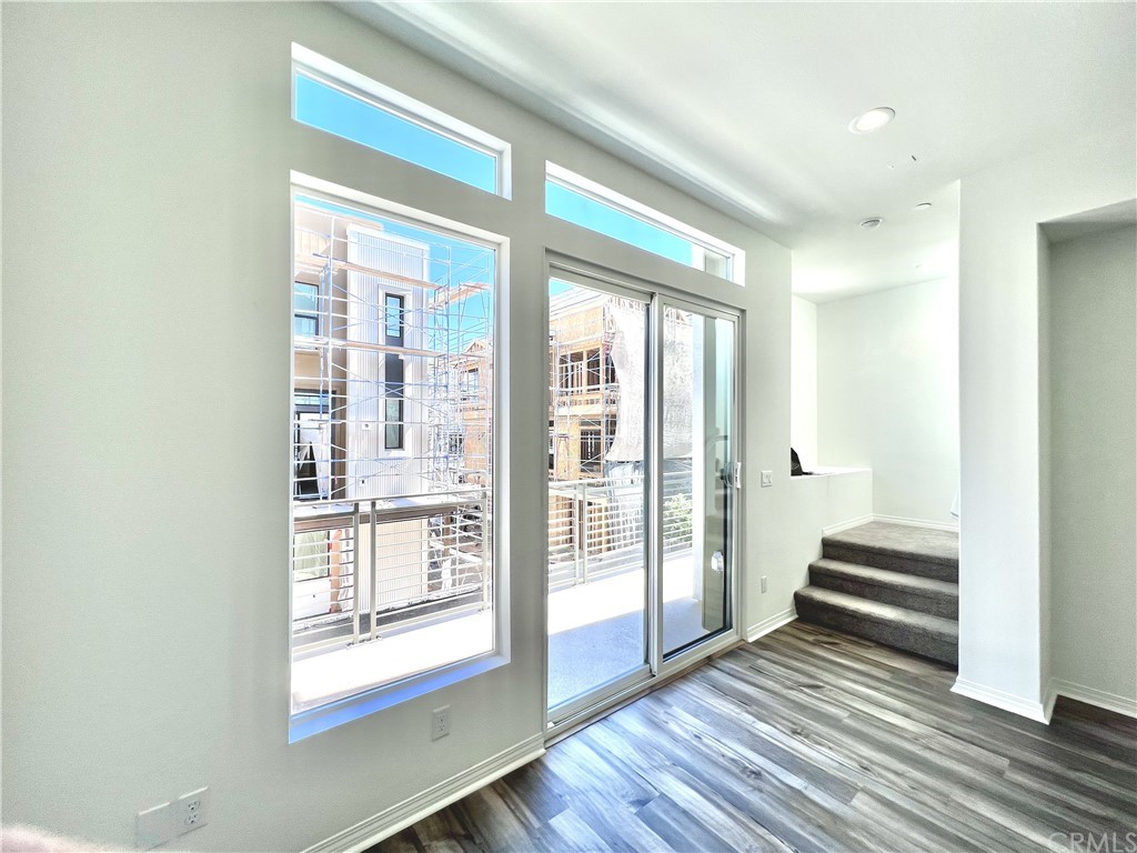 126 Sawbuck Irvine, CA 92618 - Photo 3 of 10 a view of wooden floor and windows in a room