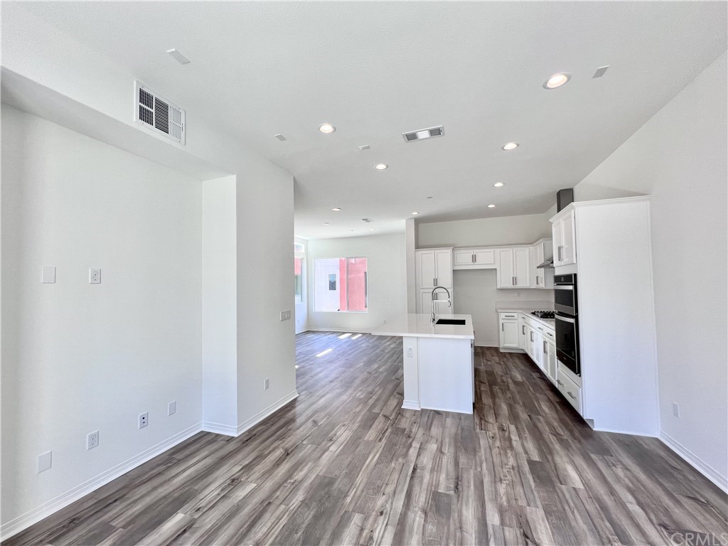 126 Sawbuck Irvine, CA 92618 - Photo 4 of 10 a kitchen with a refrigerator and a stove top oven