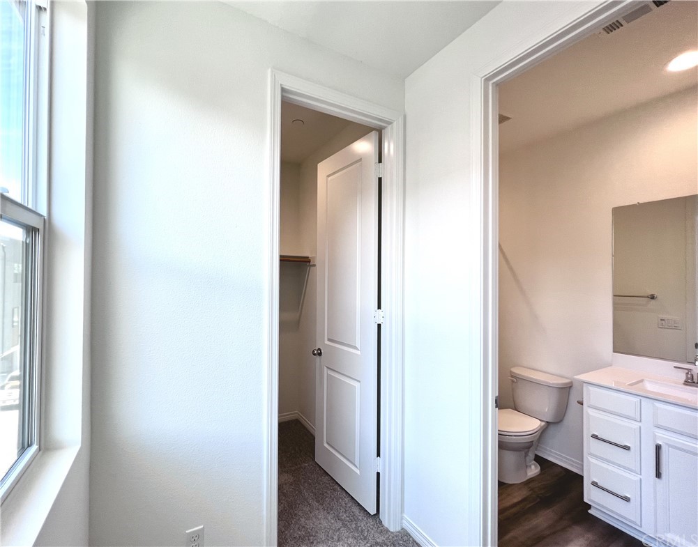 126 Sawbuck Irvine, CA 92618 - Photo 5 of 10 a bathroom with a granite countertop toilet a sink and a mirror